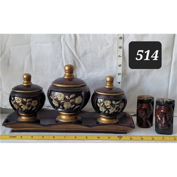 Tray with decorative covered bowls & carved wood faces.