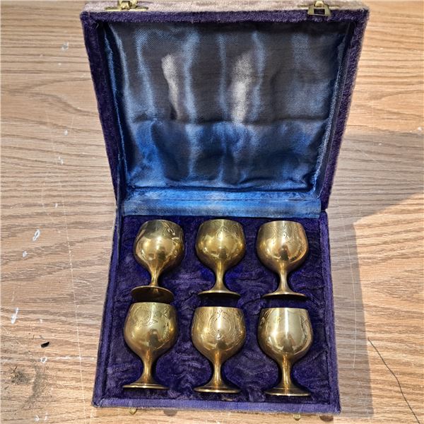 6 brass goblets in a case