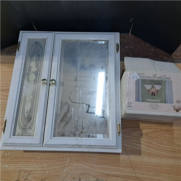 Medicine cabinet and wall light- cabinet is 27"H by 24"W