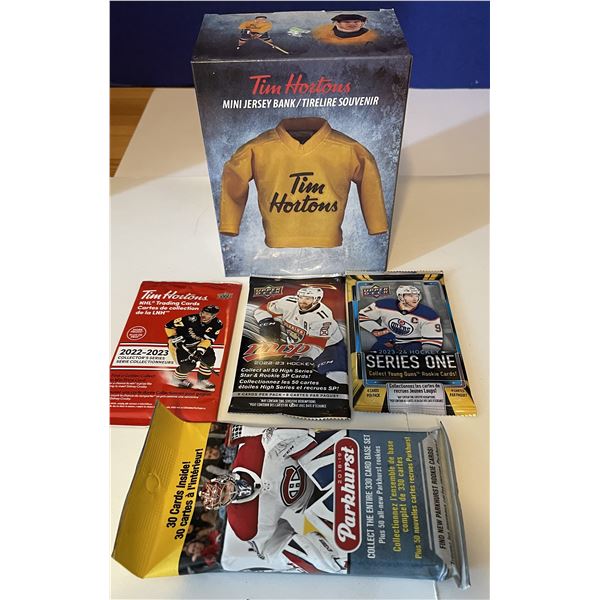 Assorted hockey card packs and a Tim Hortons Piggy Bank