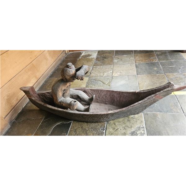 WOODEN BOAT WITH A MAN 53"X22".