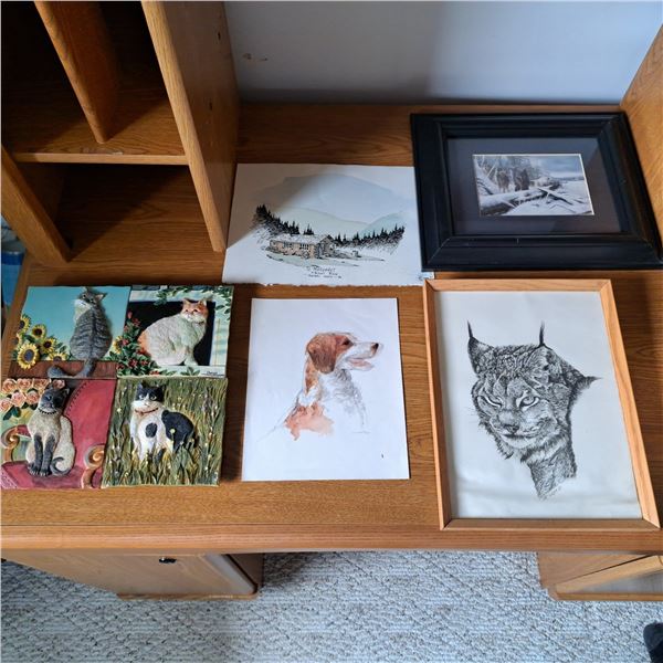 Various pictures some just paper others in frames