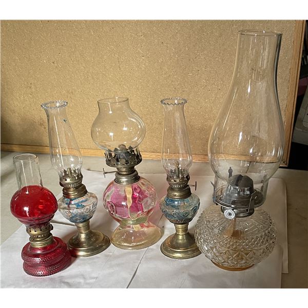 5 glass oil lamps. Tallest is 13”