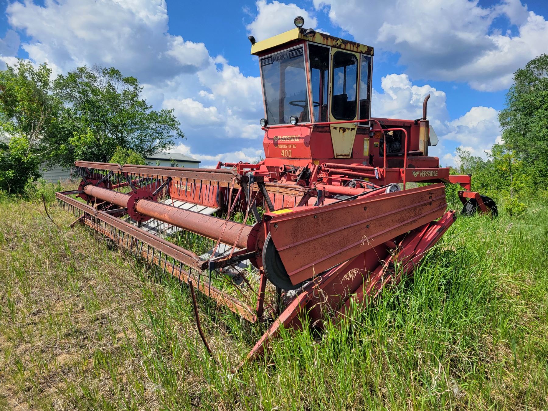 Swather Machine Versatile swather. Approx 21ft. As is, not running.