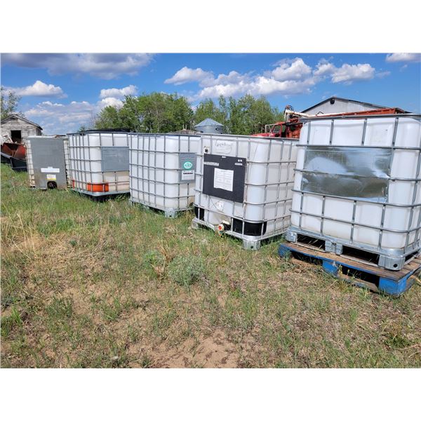 Group of 4 water totes in cages. C/w lids, valves, and 2 hoses.