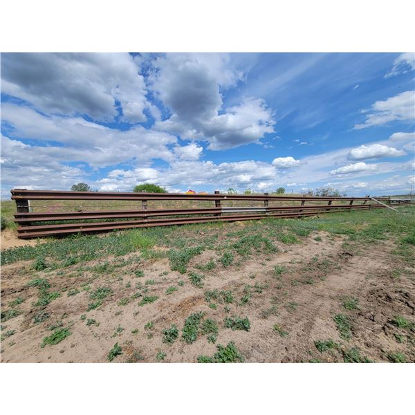 Approx 23 sections of 3 row guard rail fence, and sucker rod. (Absolute north of corral, east to wes