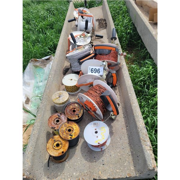 Various rolls of electric fence wire, on spools. Some rolls as new.