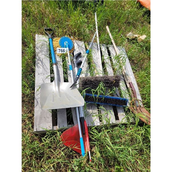 Pitch fork, brooms, shovels, flag.