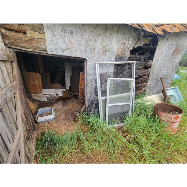 Contents of wood building including  plywood, windows, barrels and misc outside front of building