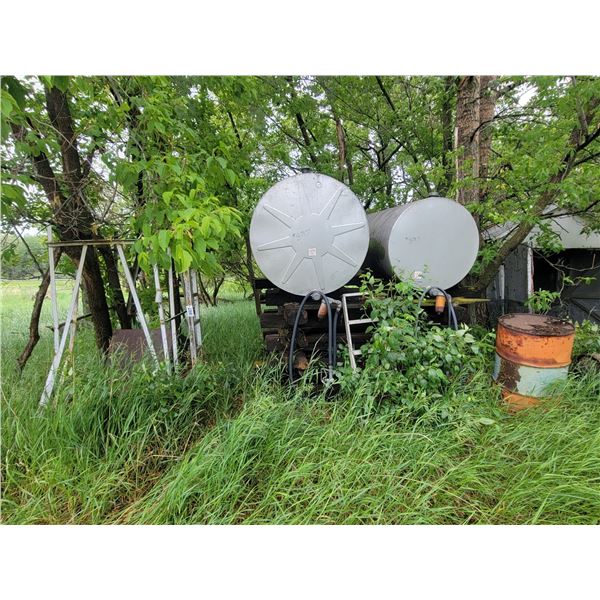 2 fuel tanks, 1 stand, jerry cans, ladder, rail road ties, barrels and misc.