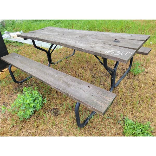 Metal stand wooden picnic table.Approx  6ft.