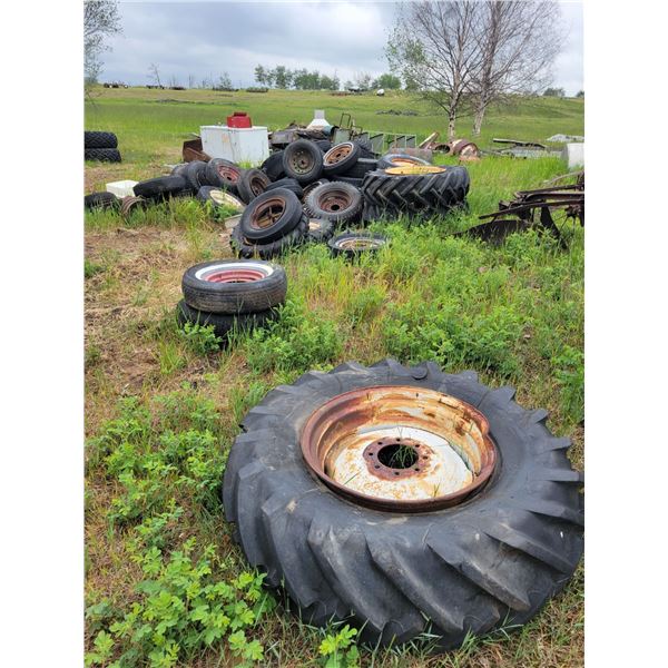 Large Qty  of scrap metal, tires on rims, trailer, barrels, track machine etc. Buyer to load out.