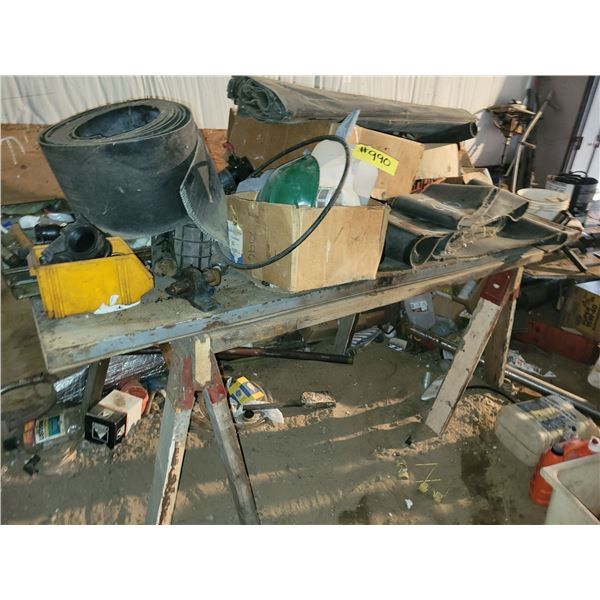 Saw horse table w/ contents. Fittings, used swather, 10" baler belt and misc.