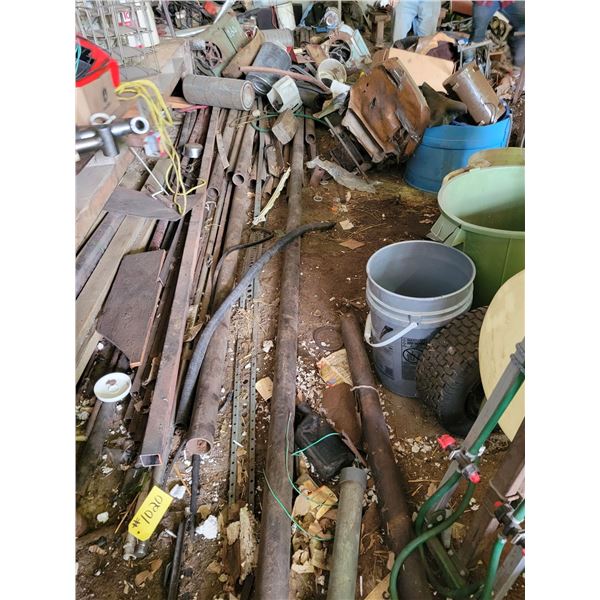 Floor of north wall of shop contents. Approx  2x6" wood boards, pipe, scrap metal etc.