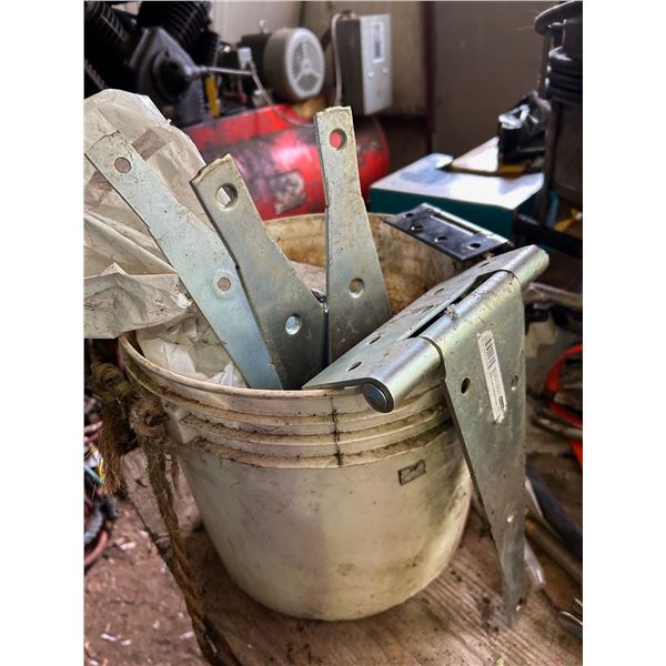 Plywood bench with contents, and contents on the floor to north. Hinges, 2" hitch, shovel, and misc.