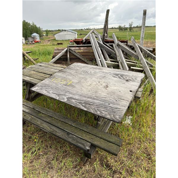 Various wood picnic tables, and signs.