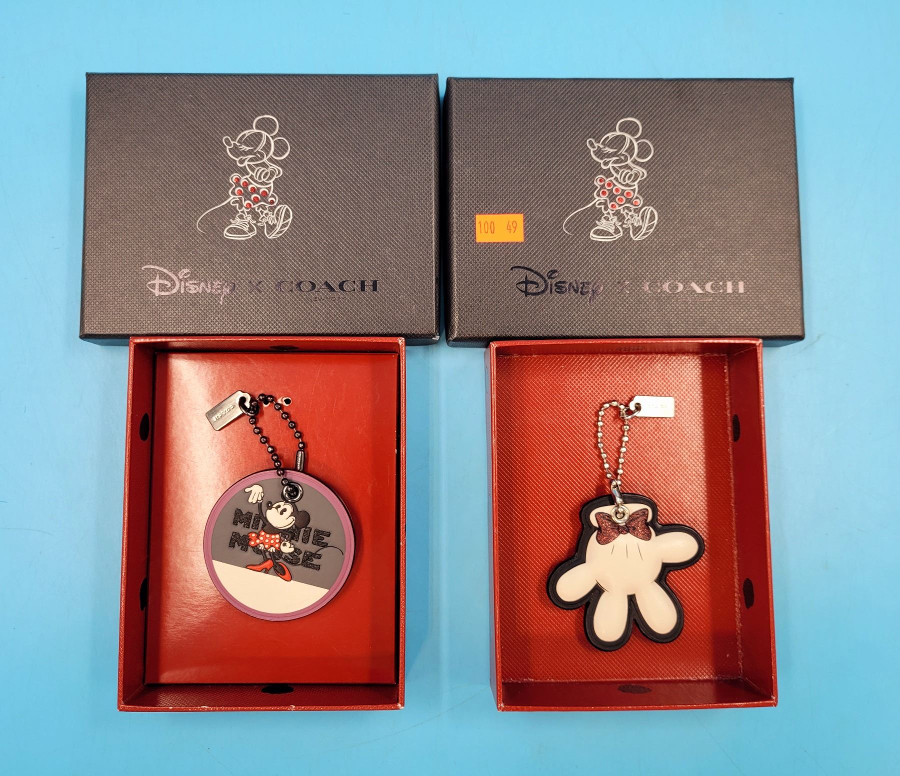 Two Disney x Coach Keychains