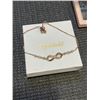 Image 2 : 2 PRENATAL BABY BUMP HEADPHONES, 2 ROSE GOLD TONED INFINITY BRACELETS AND GRILL FOR TEETH