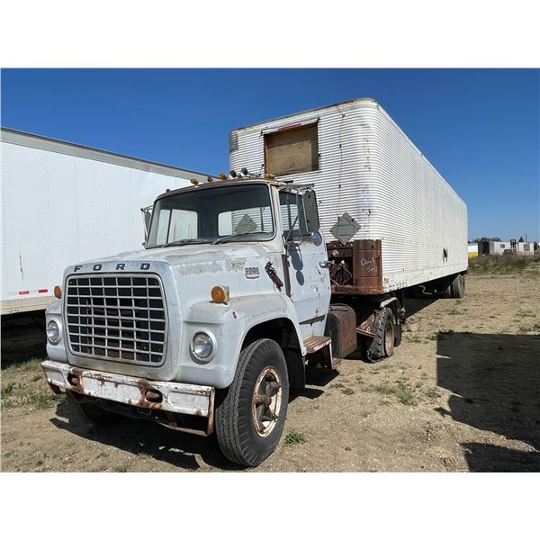 Ford 700 single axle hooked to DX. Approx 44ft, tire racks, propane tanks, tire and misc inside, sol