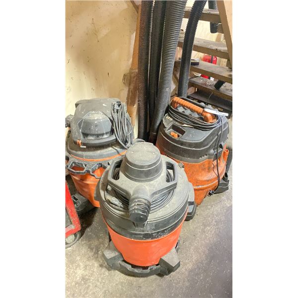 GROUP OF THREE SHOP VACUUMS WITH HOSES AND ASSORTED MISC ITEMS UNDER STAIRS
