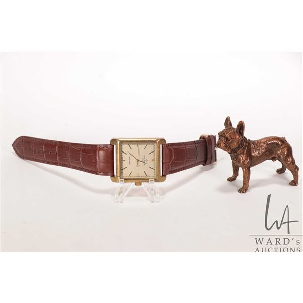 Mechanical gent's wrist watch with leather strap and a copper dog ornament