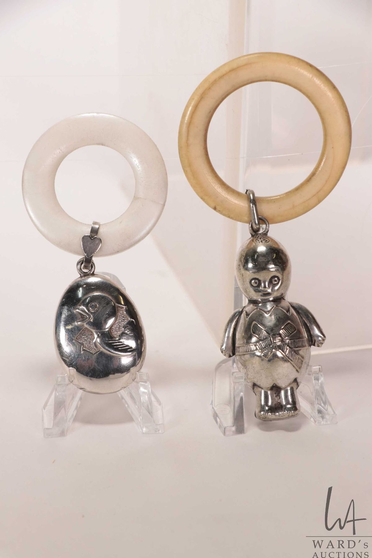 Two vintage baby rattles including baby hatching from egg, marked with ...