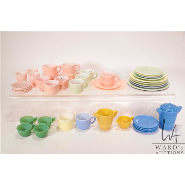 Large selection of child's glass dishware including creams and sugars, teacups and saucers, small ju