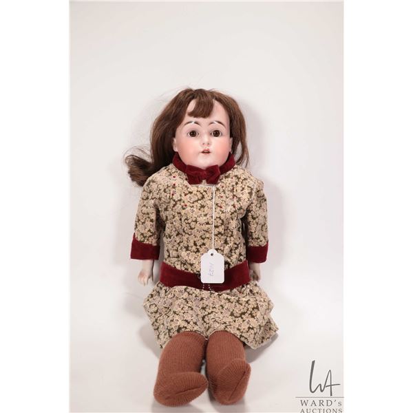Antique bisque head doll with glass sleep eyes, and open mouth, leather body and bisque hands, human