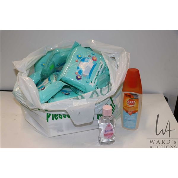 Selection of baby/child items including diaper changing kits, Huggies wipes, baby oil, family insect