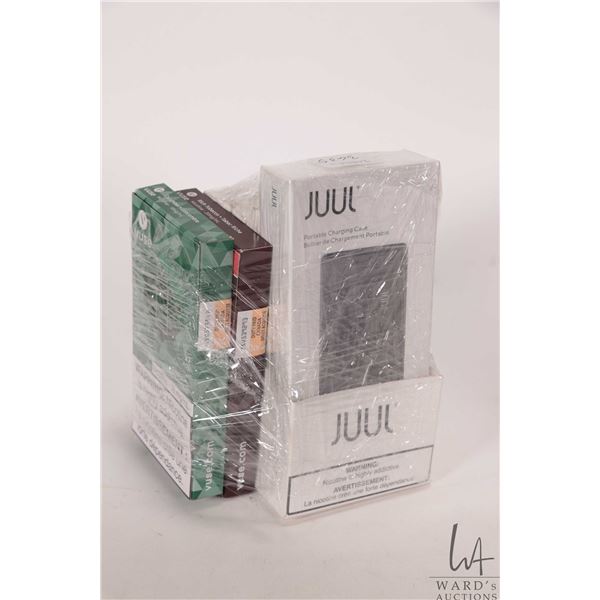 Selection of e-cigarette products including Juul portable charging case, four packages of X 2 pods J