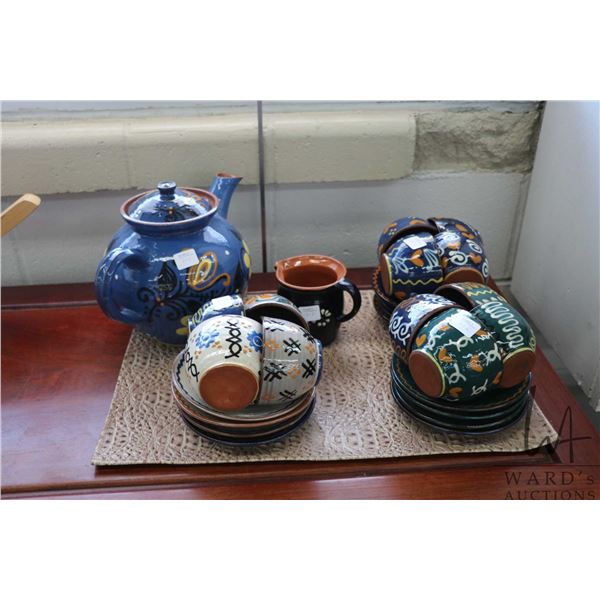 Glazed pottery tea set including teapot, cream jug, twelve cups and saucers
