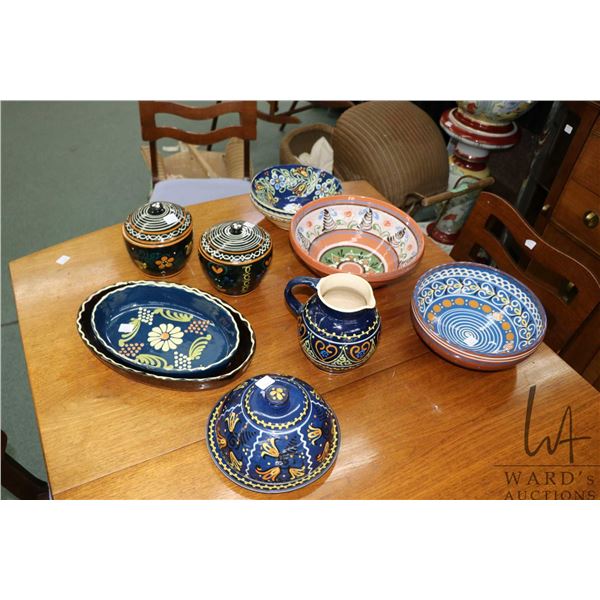 Selection of glazed pottery serving pieces including 11" and 13" casserole dishes, two 10" bowls, tw