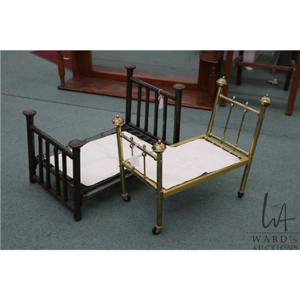 Two vintage doll beds including steel and a brass style bed
