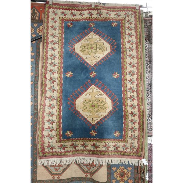 Vintage wool area rug with double medallion, blue background and highlights of sage, cream and red 4