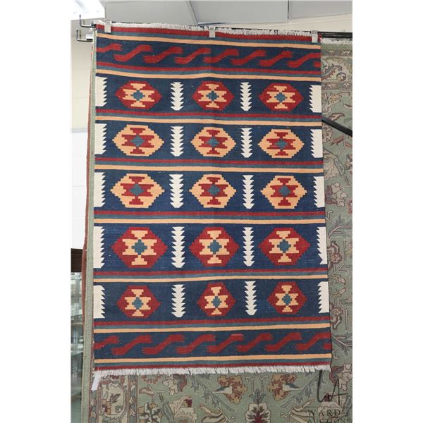 Shiraz Kilim wool carpet with geometric design, blue background and highlights of red, cream and ora