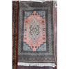 Image 1 : Wool blend throw carpet with center medallion, fringed edge and highlights of soft red, blues, black