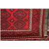 Image 2 : 100% handmade Iranian wool carpet "Baluchi" with geometric pattern, red background, and highlights o