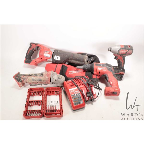 Four Milwaukee cordless power tools including driver, drywall screw gun, angle grinder and reciproca