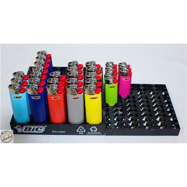 LOT OF NEW LIGHTERS IN VENDER HOLDER