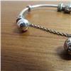 Image 4 : PANDORA bangle bracelet - 925 Silver.  Includes 4 charms and a safety chain charm.  Very nice!