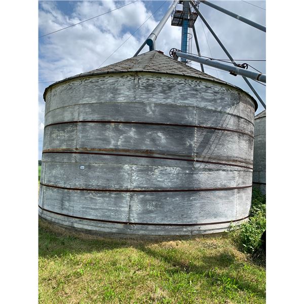 Round Wood Grain Bin on Concrete C/W auger system. Grain Bins to be Removed by Oct 1st. PH Jovi (780
