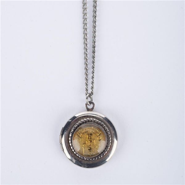 A Sleeping Beauty Castle Locket Necklace.