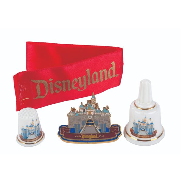 A Disneyland Pin, Bell, Thimble, and Ribbon.