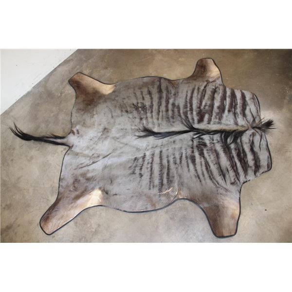 BLUE WILDEBEEST Hide Rug with Leather Piping, a Canvas Backing, and Hanging Loops