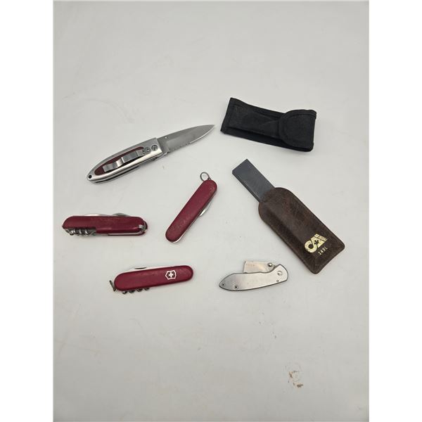 selection of pocket knives and sharpening stone