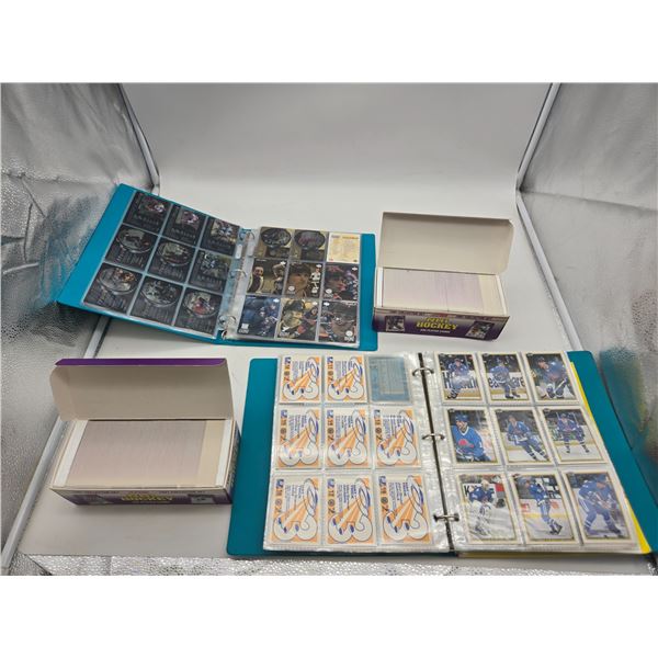 2 binders and 2 boxes of hockey cards