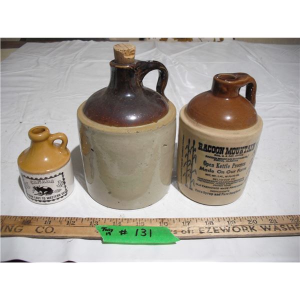 (3) stonewere jugs (2 with advertisments)