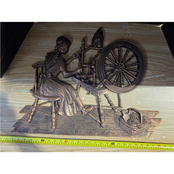 copper colored spinning wheel wall art