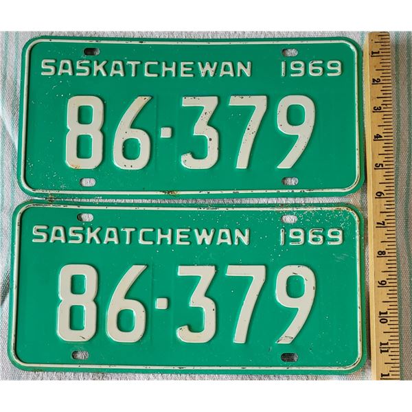 Set of two matching 1969 Saskatchewan license plates, white print on green background 86-379.