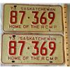 Image 1 : Set of two 73 HOME OF THE RCMP Saskatchewan license plates, red print on crackled cream background, 